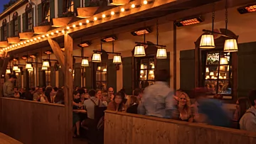 Heatscope Heaters Spot 2800W Radiant Heater wall-mounted on a restaurant terrace, outdoor electric infrared heating in Commercial Space.