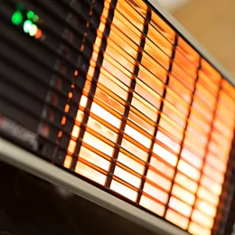 Heatscope Heaters Spot 2800W Radiant Heater wall-mounted on an outdoor restaurant terrace, electric infrared warmth.